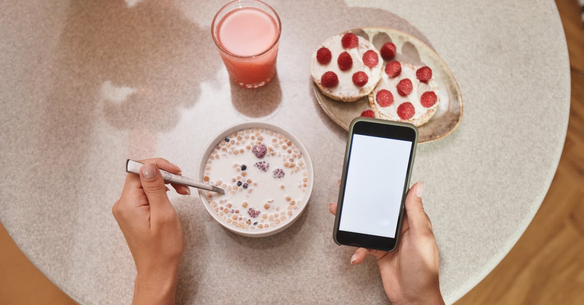 A cozy breakfast setup with cereal, toast, and a smartphone screen in view.